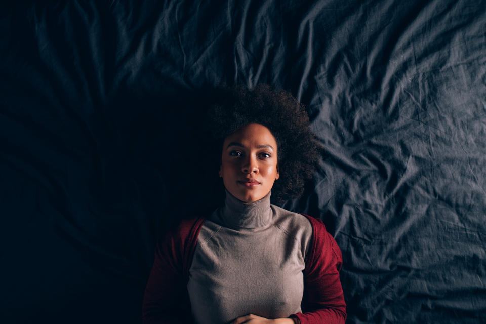 a woman laying on her bed