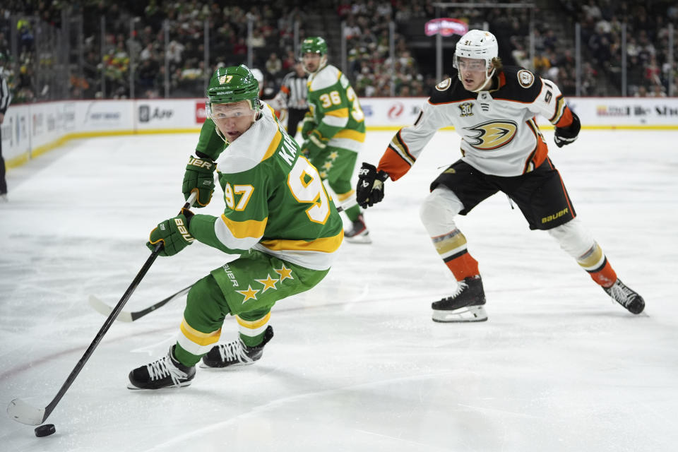 Minnesota Wild left wing Kirill Kaprizov (97) skates with the puck as Anaheim Ducks center Leo Carlsson, back, follows during the second period of an NHL hockey game Saturday, Jan. 27, 2024, in St. Paul, Minn. (AP Photo/Abbie Parr)