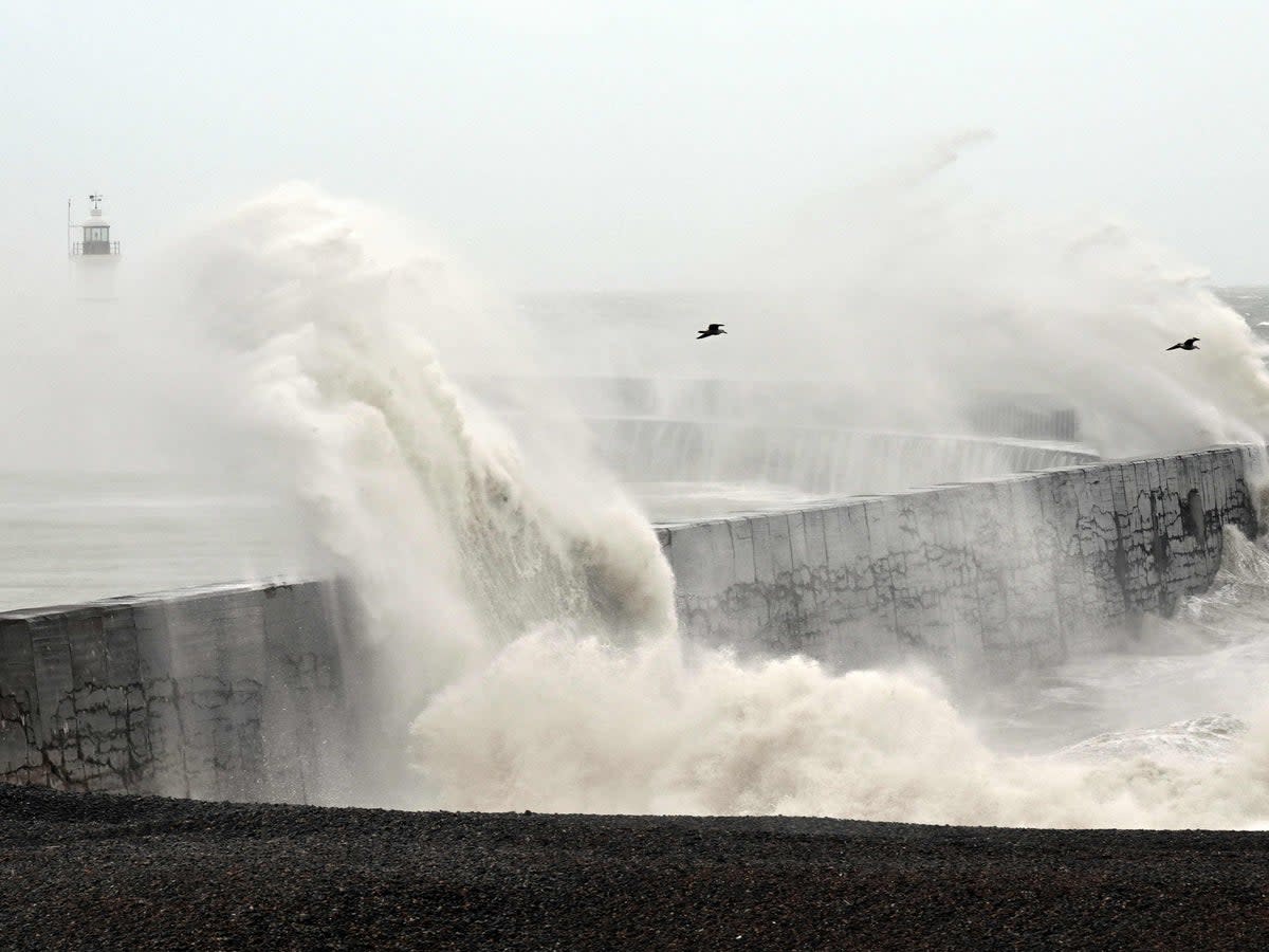 Waves break over Newhaven Lighthouse (AFP via Getty Images)