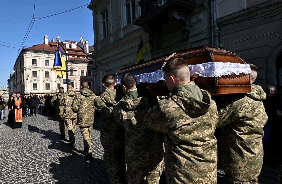 Soldiers carry a casket