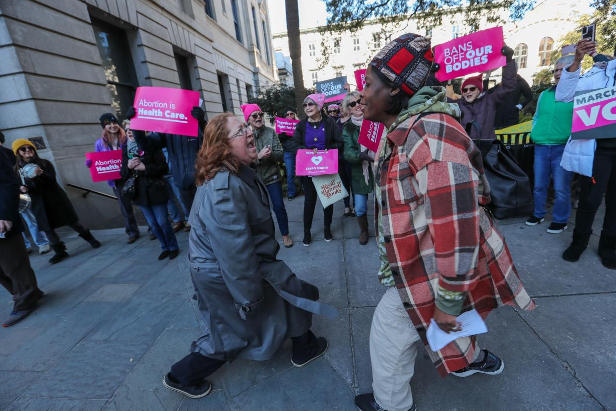 Genevieve Hawkins and Tenee Baker dance and lead a chant together during the "Bigger Than Roe" rally and march on Saturday, January 20, 2023.