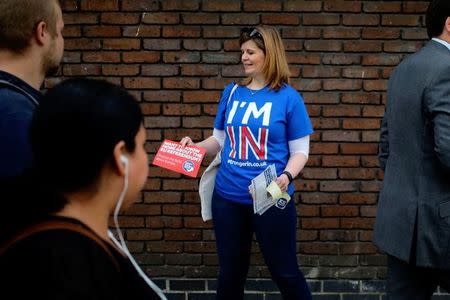 A woman hands out leaflets campaigning to stay in Europe for the BREXIT vote in London, Britain, May 20, 2016. REUTERS/Kevin Coombs