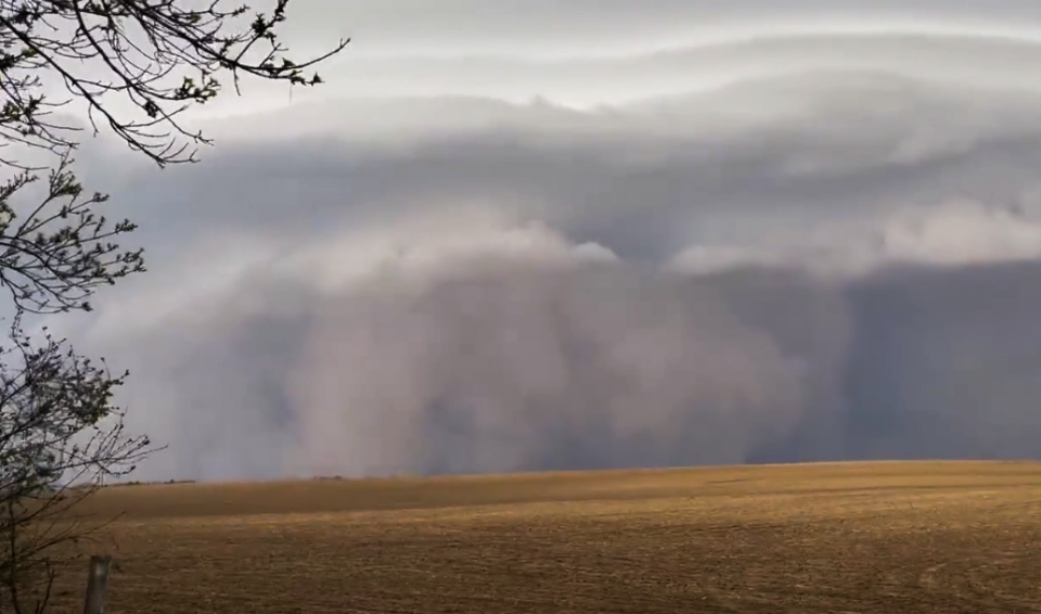 A haboob — a large wall of dust — looms a few miles away from a farm near Dell Rapids, S.D., on Thursday, May 12, 2022. Strong, hurricane-force winds from a derecho tossed topsoil into the air, leading to the dust storm's dark appearance.