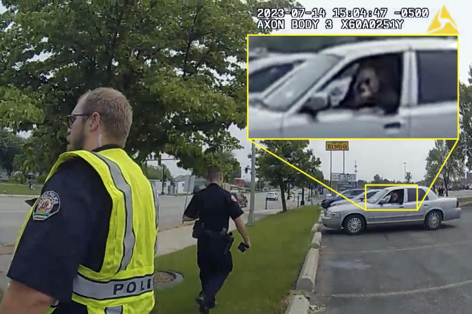 In this annotated image taken from police body camera video released by the North Dakota Attorney General's Office, Mohamad Barakat, right, points a weapon from from inside his car moments before ambushing police officers responding to a traffic accident on July 14, 2023, in Fargo, N.D. Newly released investigative reports into a shooting ambush of police officers last year in Fargo, show the gunman preparing the night before the deadly attack, loading his weapons and visiting a gun range in the hours leading up to the shooting on July 14. (North Dakota Attorney General's Office via AP)