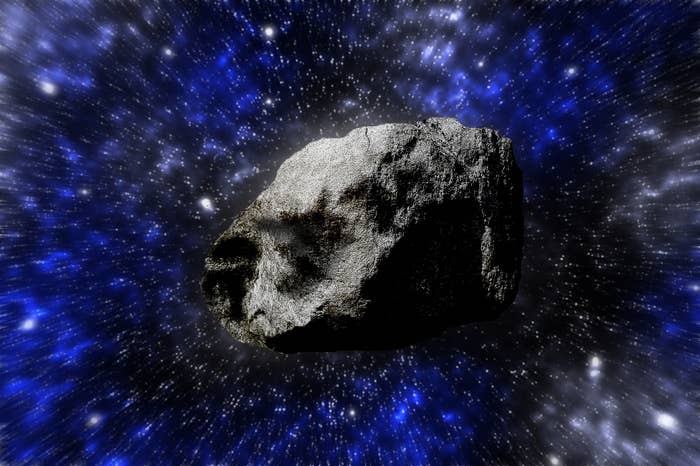 Asteroid floating in space with a starry background