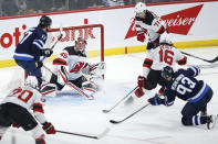 Winnipeg Jets' Kristian Vesalainen (93) scores on New Jersey Devils goaltender Jonathan Bernier (45) during the first period of an NHL hockey game Friday, Dec. 3, 2021, in Winnipeg, Manitoba. (John Woods/The Canadian Press via AP)