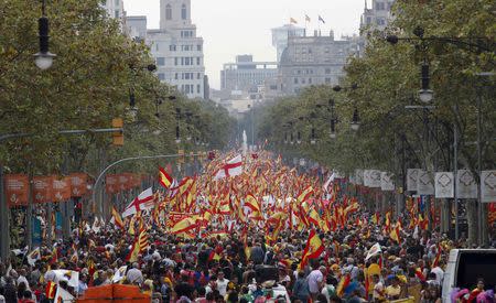 Spanish Unionist demonstrators carry Spanish flags during a demonstration on Spain's National Day in Barcelona, Spain October 12, 2018. REUTERS/Albert Gea