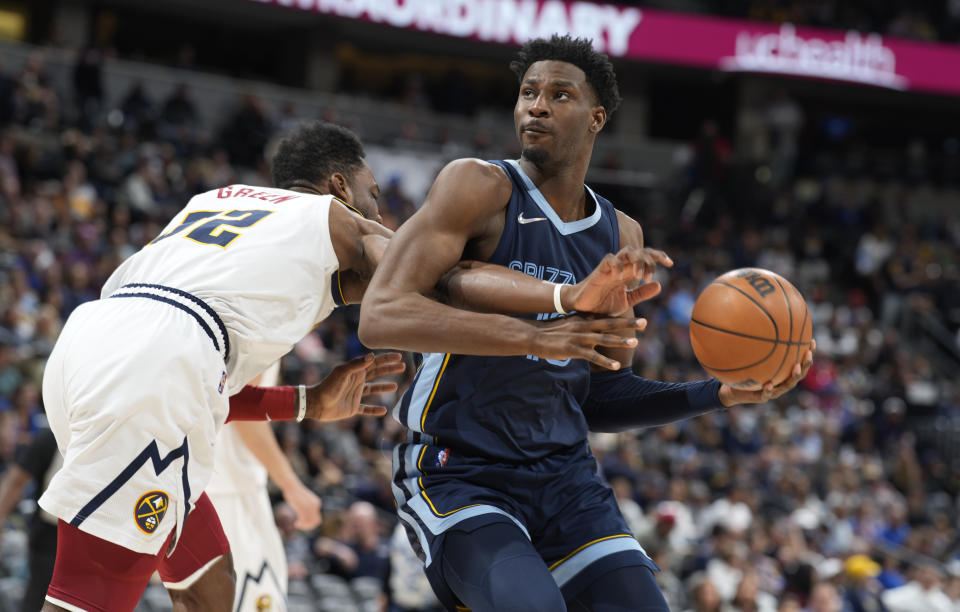 FILE - Memphis Grizzlies forward Jaren Jackson Jr., right, is fouled by Denver Nuggets forward Jeff Green during an NBA basketball game on April 7, 2022, in Denver. With Jackson recovering from surgery to fix a stress fracture in his right foot, the Grizzlies will need someone to fill in for the power forward who was coming off his best season yet. (AP Photo/David Zalubowski, File)