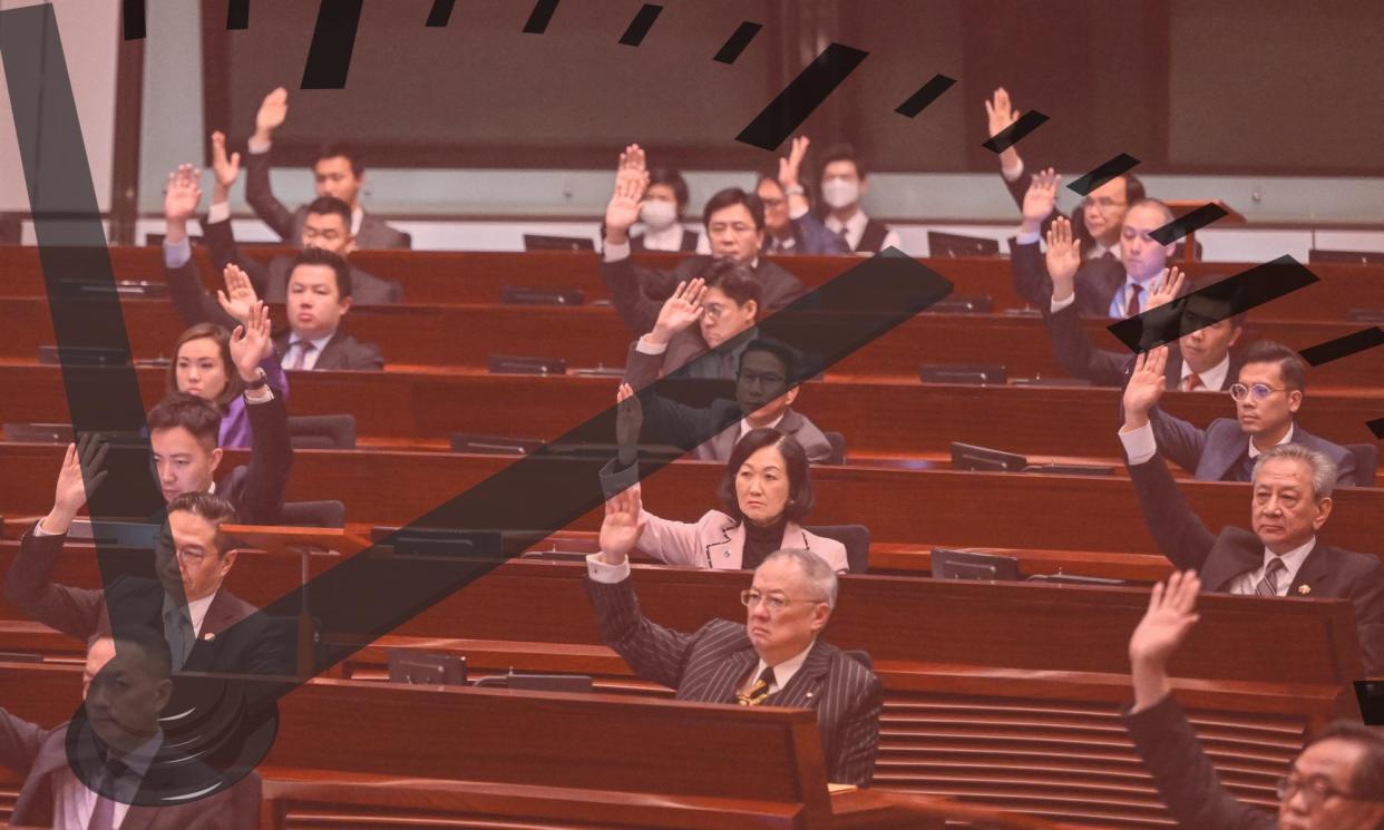 <span>Lawmakers vote for Article 23 in the chamber of the Legislative Council in Hong Kong</span><span>Composite: Getty / AFP</span>