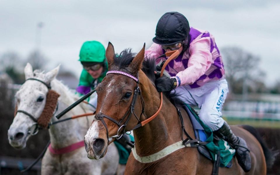 Notachance, ridden by Tom Cannon (right), clears the last to win the Classic Chase - PA