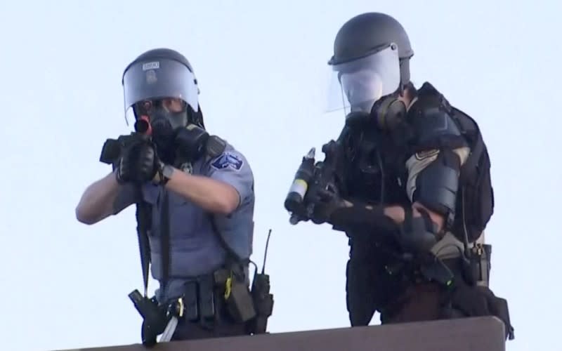 Police aim at a Reuters TV cameraman during nationwide unrest following the death of of George Floyd in Minneapolis police custody, in Minneapolis