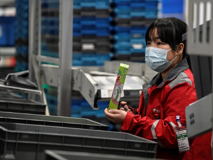 Workers at JD.com and Bilibili are getting retrenchment notices disguised as congratulatory notes for them on having &#x00201c;graduated&#x00201d; from the companies. Here, a worker sorts packages for delivery ahead of the Singles Day shopping festival which falls on November 11, at a JD.com warehouse in Beijing on November 9, 2021.
