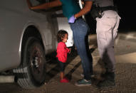 <p>A two-year-old Honduran asylum seeker cries as her mother is searched and detained near the U.S.-Mexico border on June 12, 2018 in McAllen, Texas. The asylum seekers had rafted across the Rio Grande from Mexico and were detained by U.S. Border Patrol agents before being sent to a processing center for possible separation. Customs and Border Protection (CBP) is executing the Trump administration’s “zero tolerance” policy towards undocumented immigrants. U.S. Attorney General Jeff Sessions also said that domestic and gang violence in immigrants’ country of origin would no longer qualify them for political asylum status. (Photo: John Moore/Getty Images) </p>