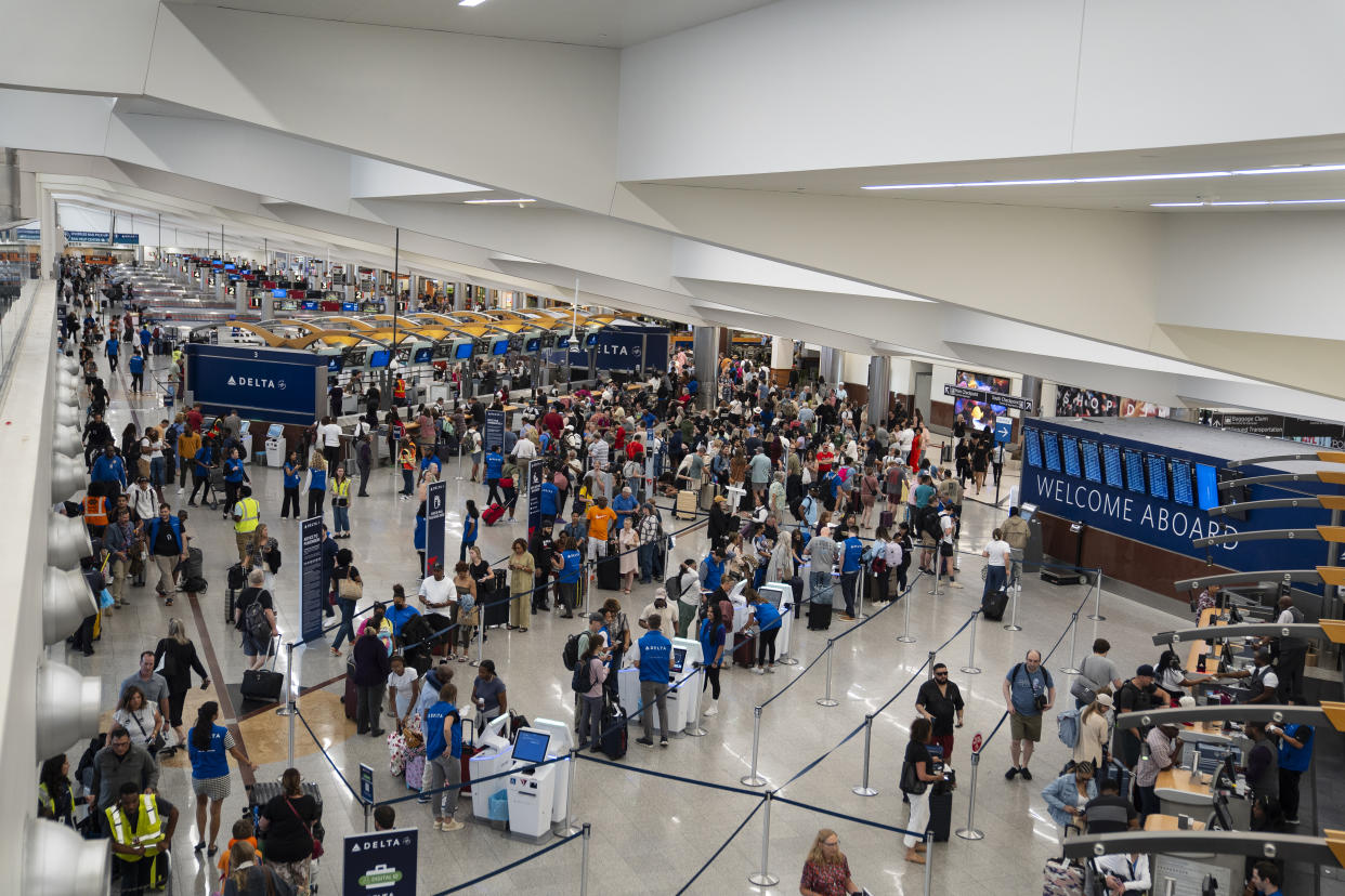 Delta passengers wait to check in following a technology outage that led to delays at Hartsfield-Jackson Atlanta International Airport, on Friday, July 19, 2024. (Nicole Craine/The New York Times)