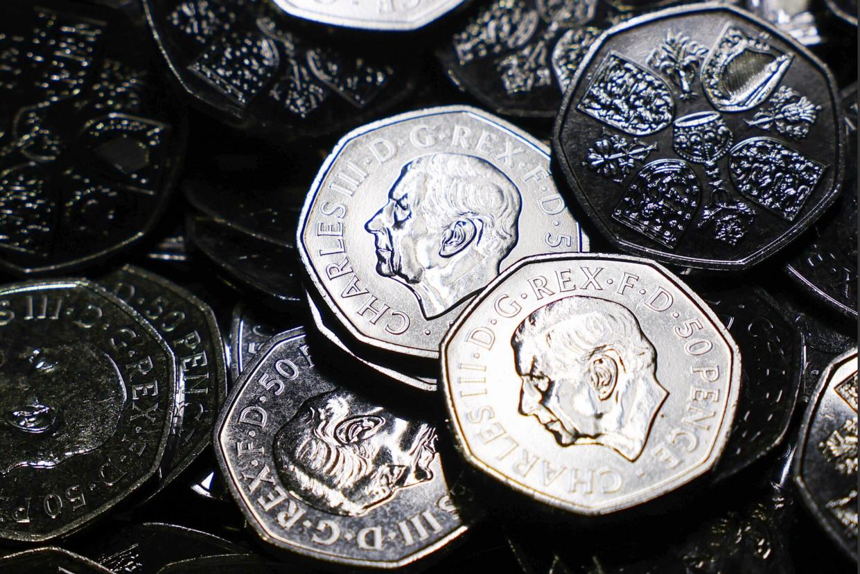 The first pressed King Charles III portrait 50-pence coins in circulation at The Royal Mint Ltd. in Pontyclun, UK, on Thursday, Oct. 27, 2022. Coins featuring King Charles III are set to enter use before Christmas in the UK, where they'll circulate alongside existing ones depicting Queen Elizabeth II.