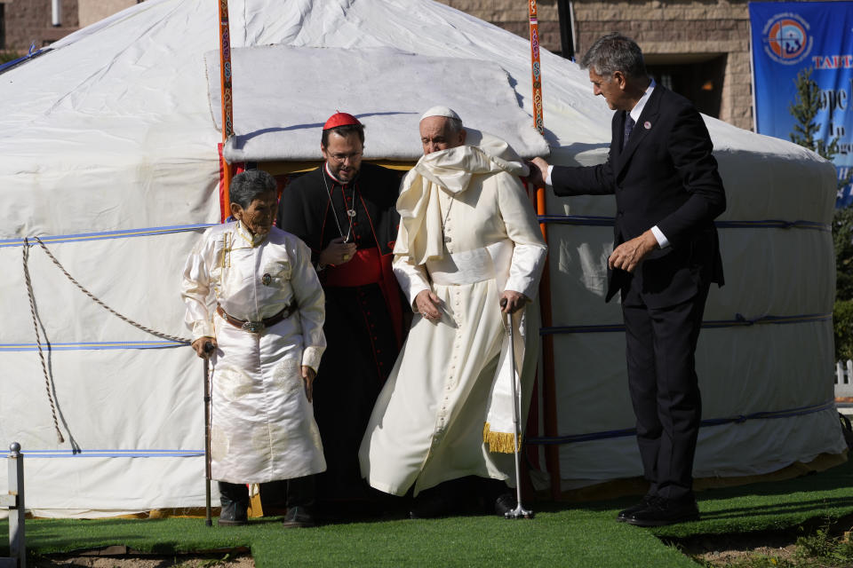 Mrs. Tsetsege, left, meets Pope Francis, helped by his aide Sandro Mariotti, right, with Apostolic Prefect of Ulaanbaatar, Cardinal Giorgio Marengo, second from left, at Saints Peter and Paul Catholic Cathedral in Ulaanbaatar, Saturday, Sept. 2, 2023, before a meeting with Pope Francis and the local clergy. Some ten years ago Tsetsege found in the rubbish a wooden statuette of the Virgin Mary that was later installed inside the Cathedral when it was built in 1996. (AP Photo/Andrew Medichini)