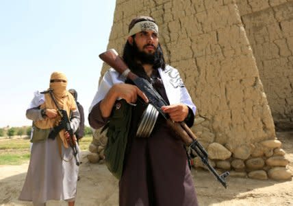 FILE PHOTO: Taliban walk as they celebrate ceasefire in Ghanikhel district of Nangarhar province, Afghanistan June 16, 2018.REUTERS/Parwiz/File Photo