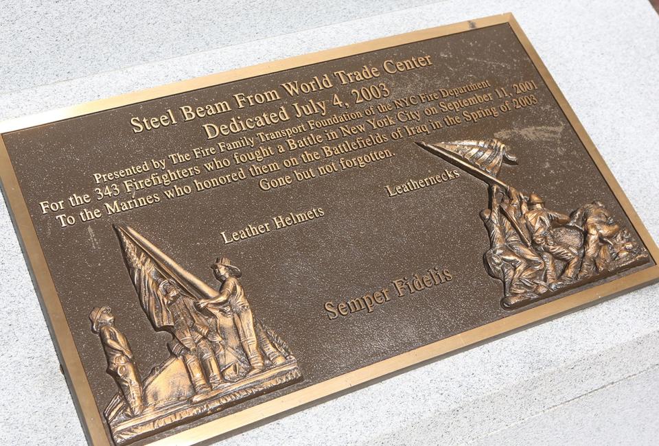 A photo of the plaque on the 9/11 Memorial Beam located at the Lejeune Memorial Gardens in Jacksonville.