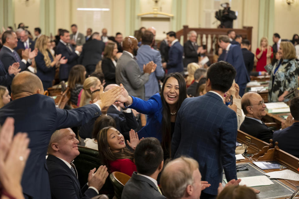 Assemblymember Stephanie Nguyen, center, of District 10 celebrates Assemblyman Kevin McCarty of District 7 after being sworn in during the opening session of the California Legislature in Sacramento, Calif., Monday, Dec. 5, 2022. The legislature returned to work on Monday to swear in new members and elect leaders for the upcoming session. (AP Photo/José Luis Villegas, Pool)