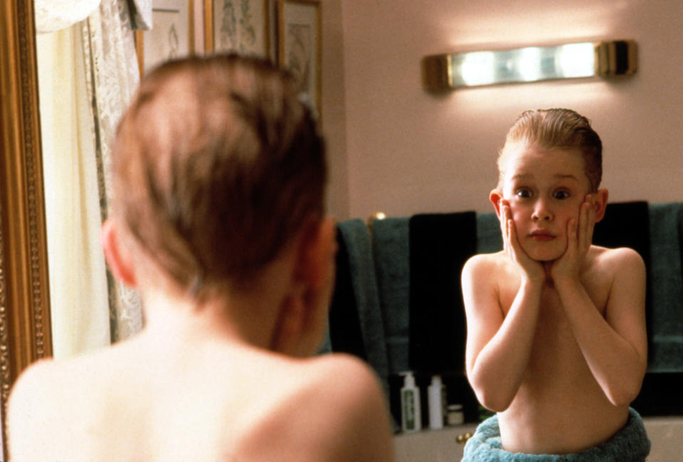 Macaulay Culkin looking at himself in the mirror.