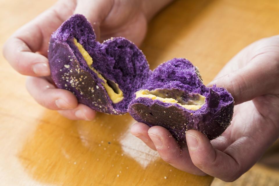 An ube pandesal and its cheese filling at Three Bites Bakery
