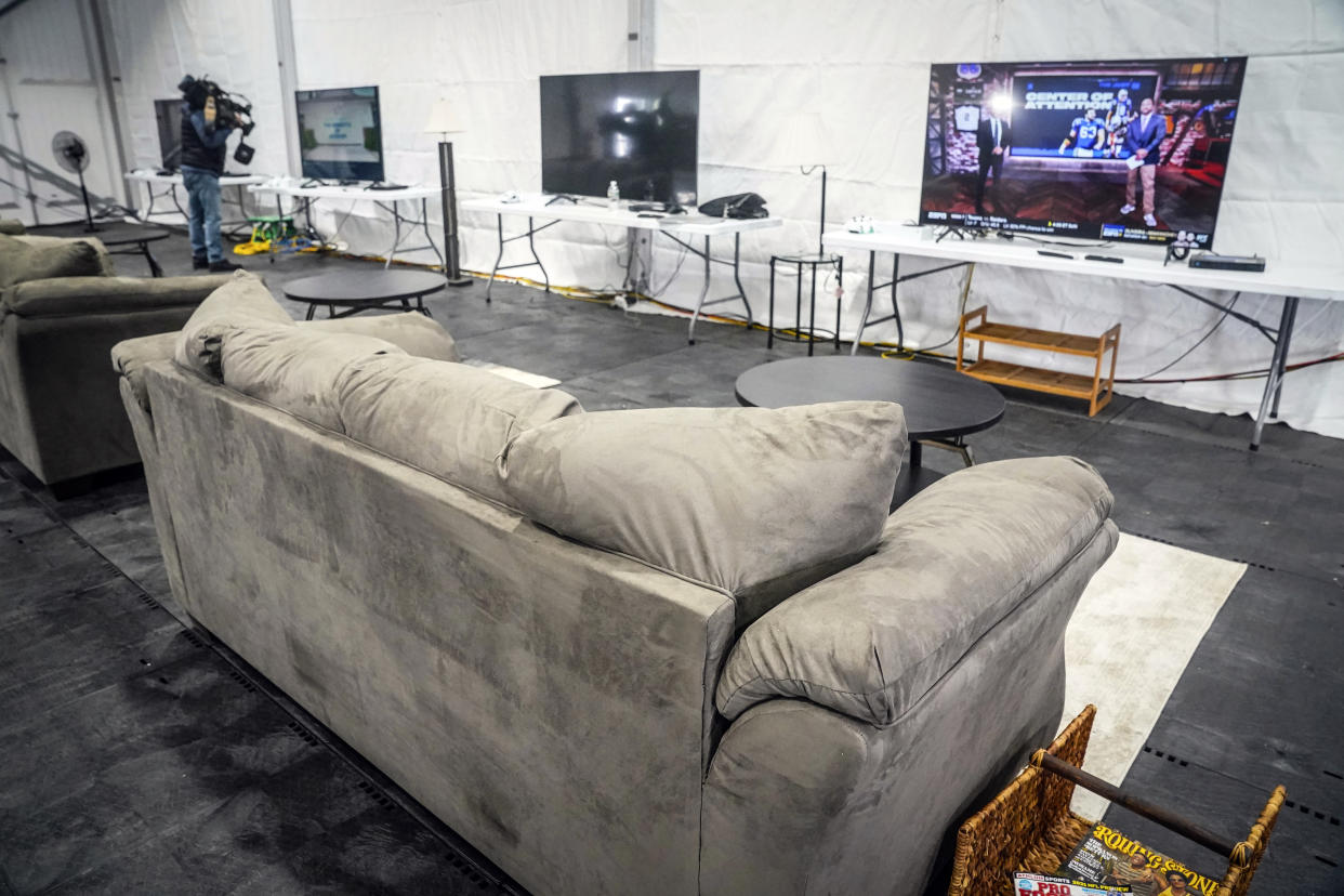 A an entertainment area, shown during a press tour, is part of New York City's latest temporary shelter on Randalls Island for migrants being bused into the city by southern border states, Oct. 18, 2022, in New York. The shelter will start taking in single adult men on Wednesday, with facilities including laundry, regular meals and a mass sleeping area. (AP Photo/Bebeto Matthews)