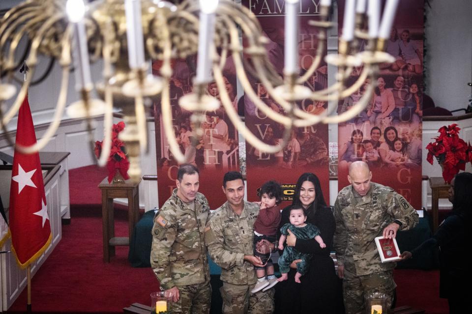 Lt. Gen. Chris Donahue, left, and Command Sgt. Maj. Bryan Barker, right, pose with family of the year winner, First Lt. Nasser Hassoun and his wife, Emily, and their children, Elias and Eliana, at the Fort Liberty Family of the Year ceremony on Thursday, Nov. 30, 2023.