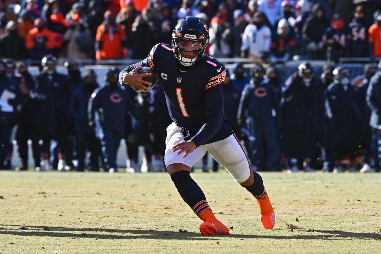 Chicago Bears quarterback Justin Fields runs with the ball during a Dec. 24, 2022 game against the Buffalo Bills at Soldier Field.