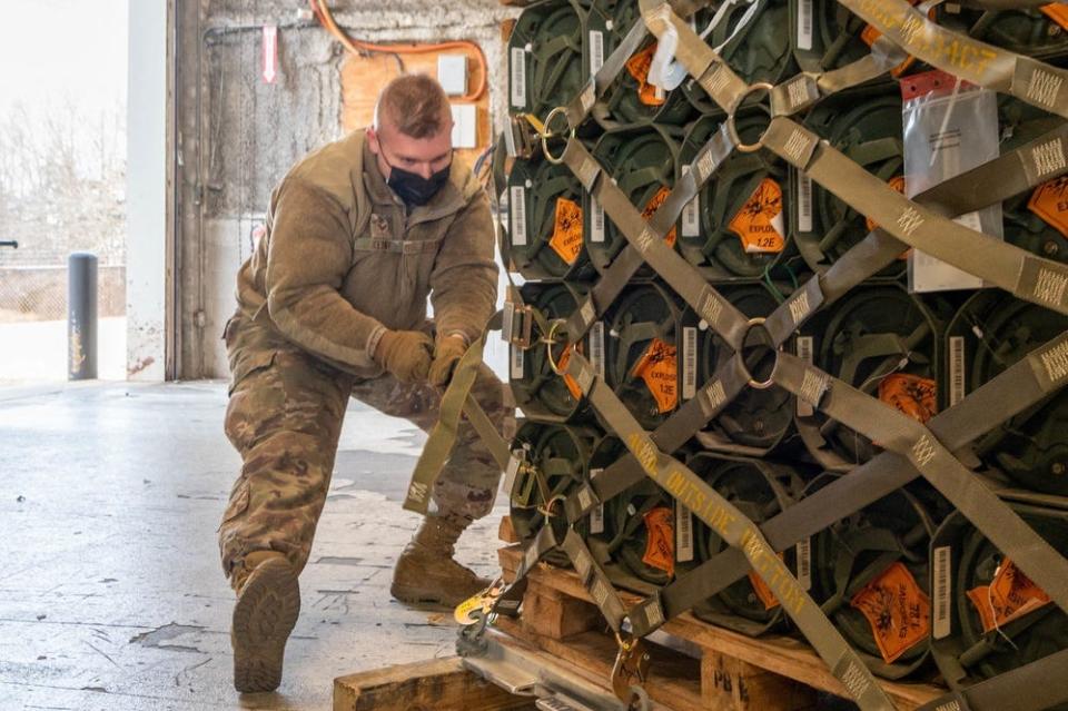 This handout photo courtesy of US Air Force taken on Friday shows Senior Airman Zachary Kline, 436th Aerial Port Squadron cargo processor, palletizes ammunition, weapons and other equipment bound for Ukraine during a foreign military sales mission at Dover Air Force Base, Delaware.