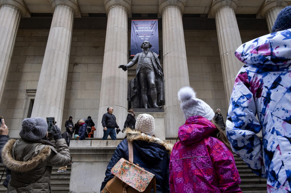 People stand near a statue of George Washington on Dec. 22, 2018, at the closed Federal Hall National Memorial in New York. (Photo: Craig Ruttle/AP)