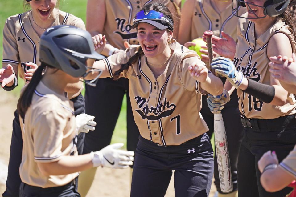 North Kingstown's Riley McHale waits to give Gabriella Peralta a hug at home plate after Peralta's third-inning home run in Monday's matinee against Bay View, where the young Skippers picked up their first win of the season.