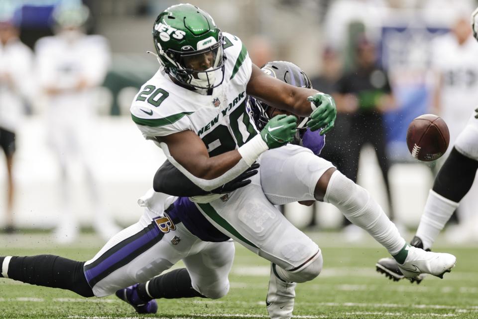 New York Jets running back Breece Hall (20) fumbles the ball during the second half of an NFL football game against the Baltimore Ravens, Sunday, Sept. 11, 2022, in East Rutherford, N.J. Ravens' Marlon Humphrey recovered the ball on the play. (AP Photo/Adam Hunger)