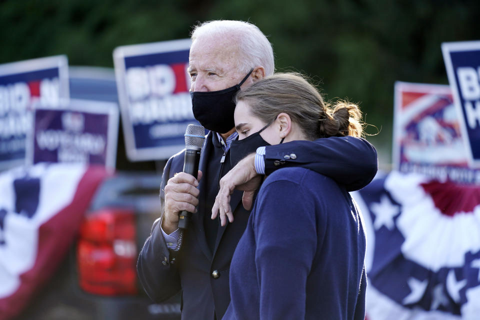 Democratic presidential candidate former Vice President Joe Biden and former President Barack Obama speak with people at Birmingham Unitarian Church in Bloomfield Hills, Mich., Saturday, Oct. 31, 2020, with granddaughter Maisy Biden. (AP Photo/Andrew Harnik)