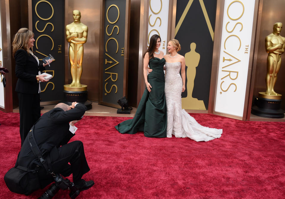 Idina Menzel, left, and Kristen Bell arrive at the Oscars on Sunday, March 2, 2014, at the Dolby Theatre in Los Angeles. (Photo by Jordan Strauss/Invision/AP)