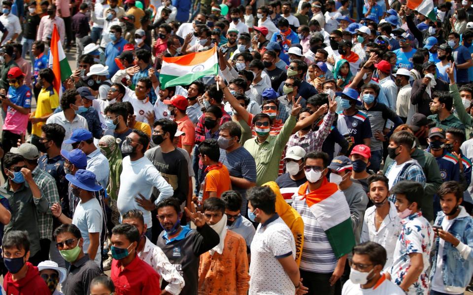 Fans react as they wait to enter the newly named Narendra Modi Stadium in India  - Amit Dave/Reuters