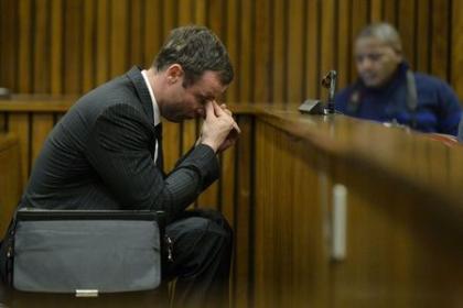 Oscar Pistorius sits in the dock during the closing defence arguments in the North Gauteng High Court in Pretoria August 8, 2014. REUTERS/Herman Verwey/Pool