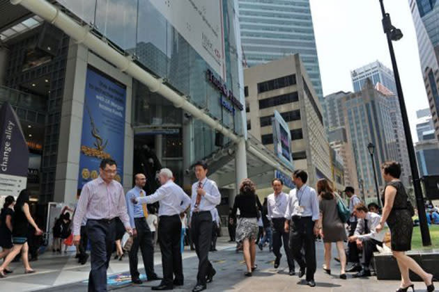 People walk through Raffles Place in Singapore on October 1, 2012. (AFP photo)