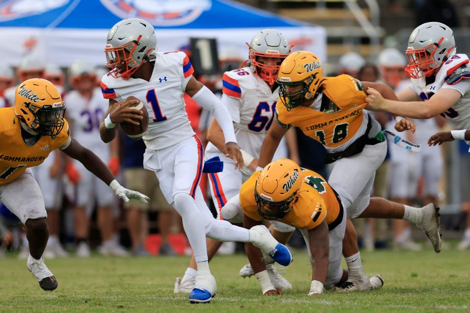 Bolles quarterback DJ Moore (1) rolls out from the pocket during the second quarter of Friday's spring football game at White.