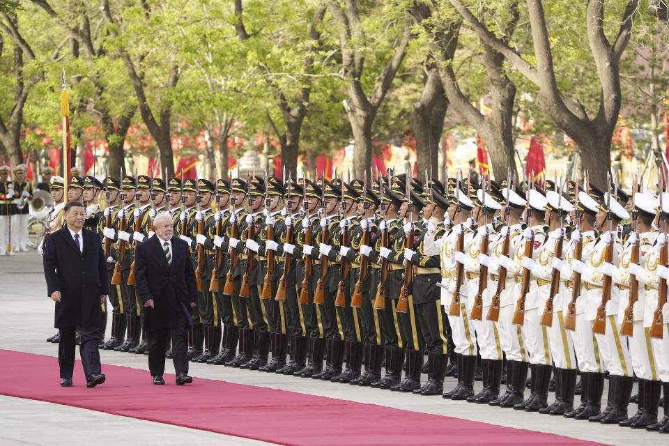 Brazilian President Luiz Inacio Lula da Silva, right, and Chinese President Xi Jinping review an honor guard during a welcome ceremony at the Great Hall of the People in Beijing, China, Friday, April 14, 2023. (Ken Ishii/Pool Photo via AP)