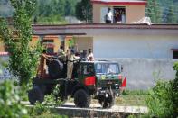 Pakistani army soldiers leave the area near the hideout of Al-Qaeda leader Osama bin Laden