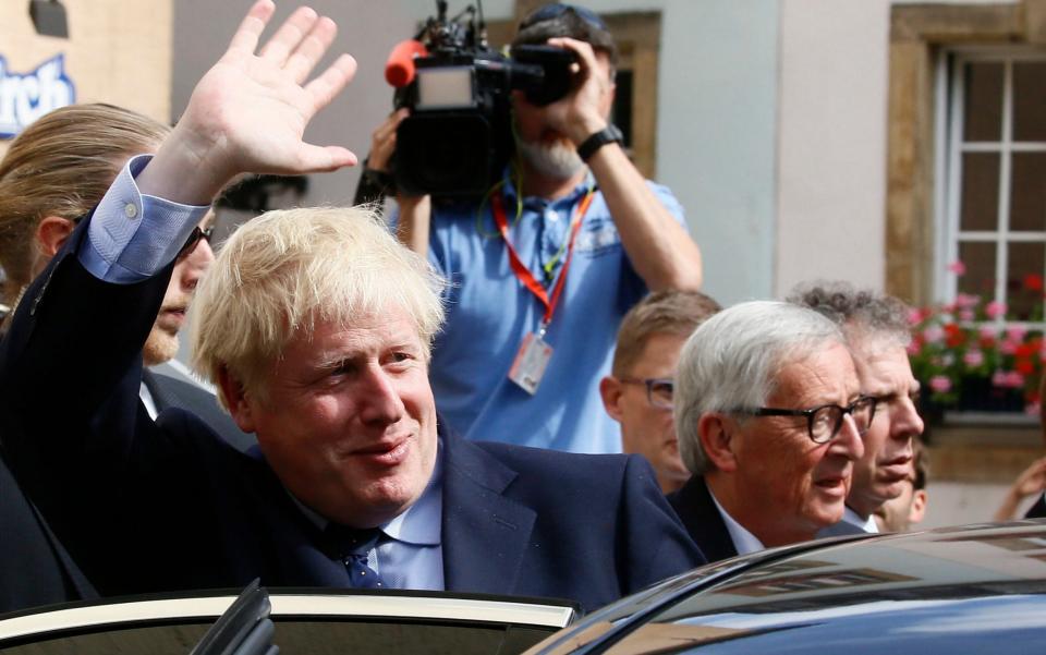 Putting a brave face on? Boris Johnson waves as he leaves a lunch meeting with European Commission President Jean-Claude Juncker in Luxembourg yesterday - REX