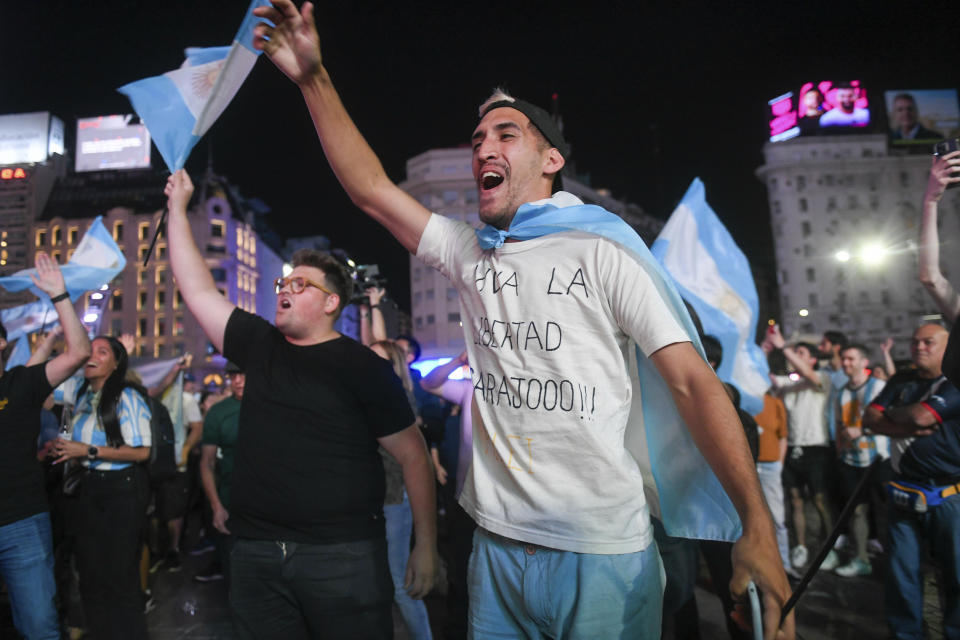 Supporters of Javier Milei, candidate of the Liberty Advances coalition, celebrate his victory over Sergio Massa, the Economy Minister and candidate of the Peronist party, in the presidential runoff election in Buenos Aires, Argentina, Sunday, Nov. 19, 2023. (AP Photo/Gustavo Garello)