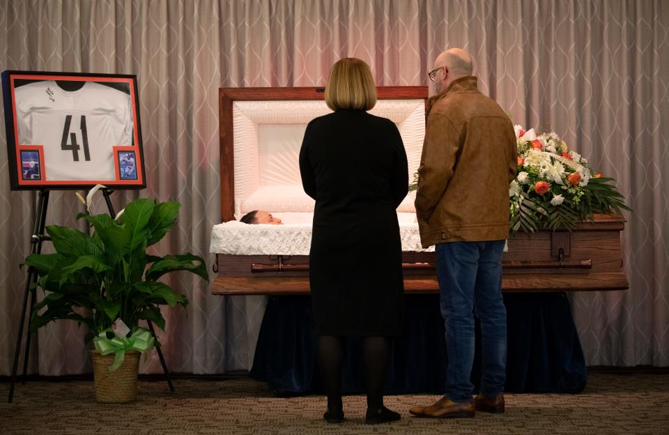 Felisha Zimmerman and close friend, Danny Ashbrook, say a final goodbye to Kristopher Teetor, 17, during a viewing at the Newcomer Funeral Home in Westwood, Nov. 29, 2021. Teetor was shot to death the evening of Nov. 6, 2021, after buying juice at the BP food mart in South Fairmont. Joseph Bazel III, 24, was arrested Nov. 23, 2021 and charged with aggravated murder for the shooting. Teetor is the son of Brian and Felisha Zimmerman. The couple lost a second son, Brian Crouse Jr., 18, to gun violence on July 25, 2017. 