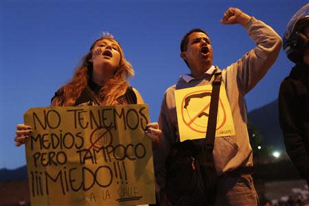 Opposition demonstrators march during a protest against President Nicolas Maduro's government in Caracas February 13, 2014. REUTERS/Carlos Garcia Rawlins