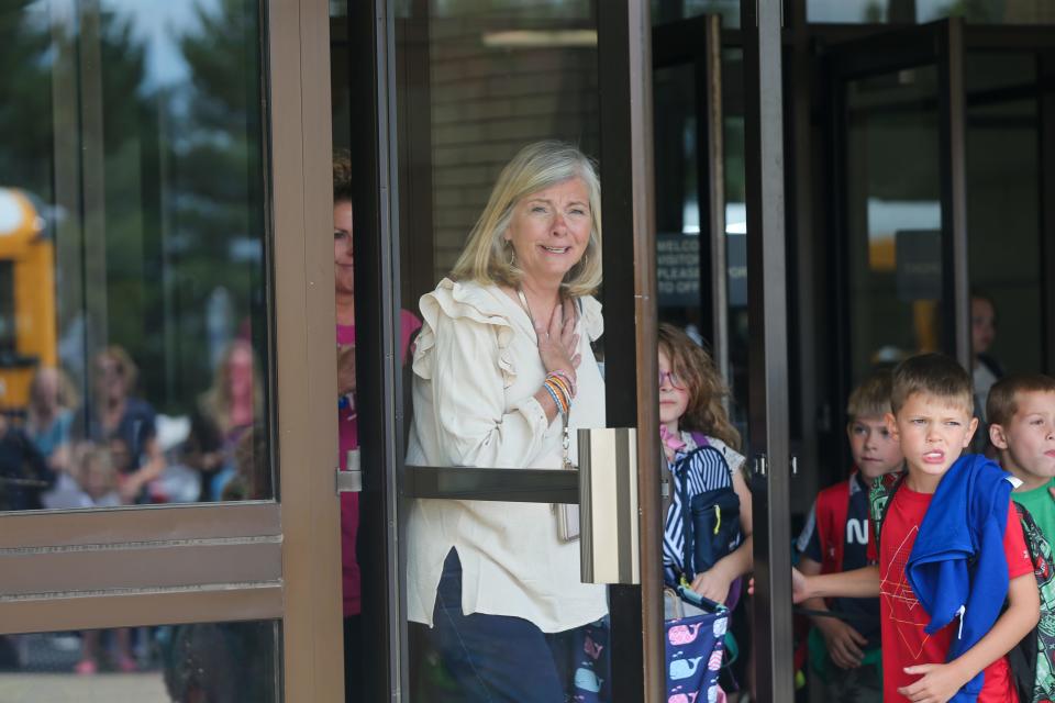 Kelly Curtis, first grade teacher at James Cole Elementary school, becomes visible surprised when she notices her friends, co-workers, and family members waiting to say goodbye to Curtis on her last as a teacher, on Thursday, May 25, 2023, in Lafayette, Ind.