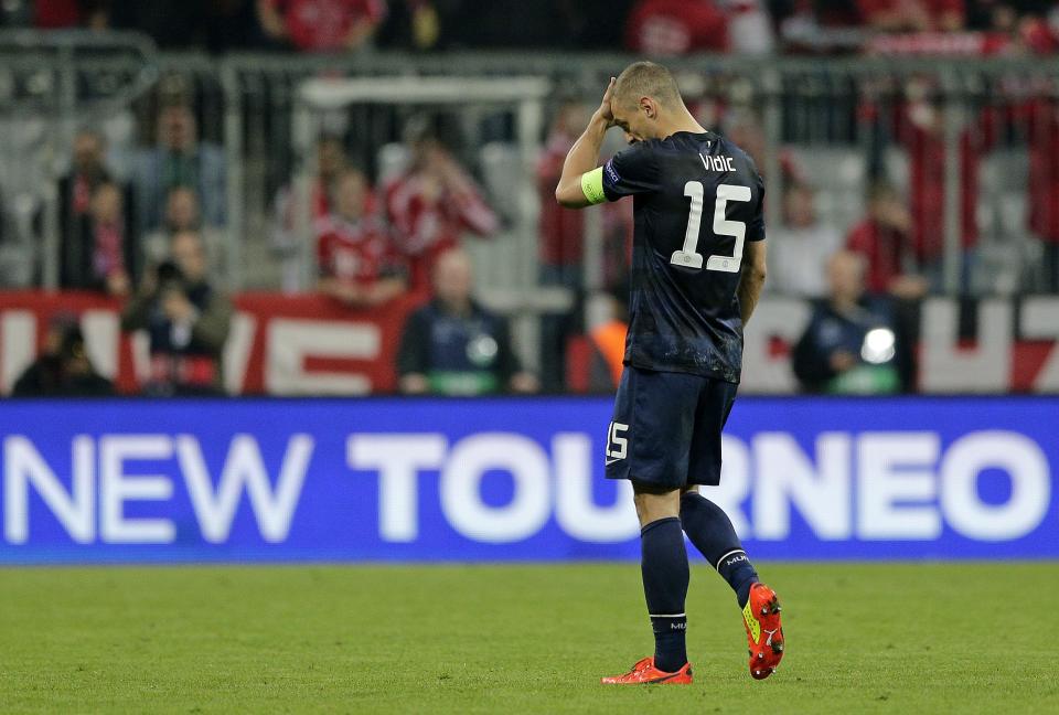 Manchester United's Nemanja Vidic leaves the field at the end of the Champions League quarterfinal second leg soccer match between Bayern Munich and Manchester United in the Allianz Arena in Munich, Germany, Wednesday, April 9, 2014. Bayern won 3-1 to win the tie 4-2 on aggregate.(AP Photo/Matthias Schrader)