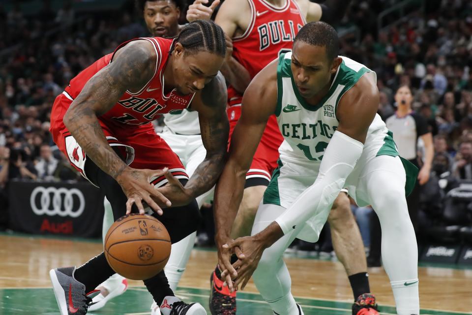 Chicago Bulls' DeMar DeRozan (11) battles Boston Celtics' Al Horford (42) for a loose ball during the first half of an NBA basketball game, Monday, Nov. 1, 2021, in Boston. (AP Photo/Michael Dwyer)