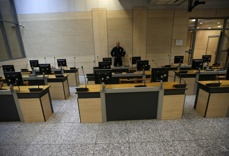 A court security guard stands in the empty room of The Organized Crime court prior to the sentencing of Darko Saric leader of a criminal organization, in Belgrade, Serbia, Monday, Dec. 10, 2018. A Serbian court has sentenced a Balkan drug lord to 15 years in prison for smuggling 5.7 tons of cocaine from South America to Europe. (AP Photo/Darko Vojinovic)