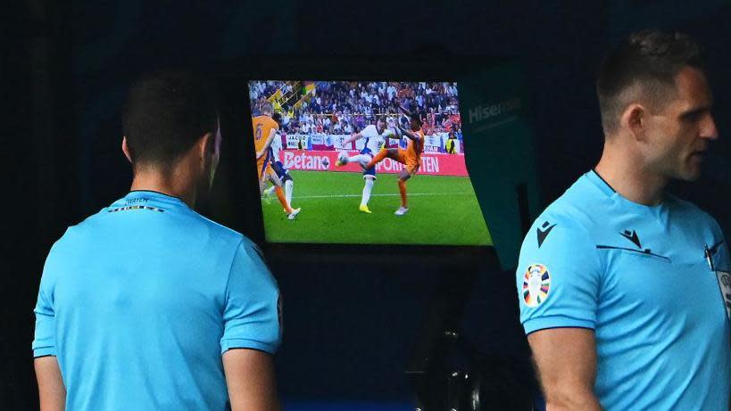 The referee watches the replay for a foul on Harry Kane during the Euro 2024 semi-final between England and the Netherlands