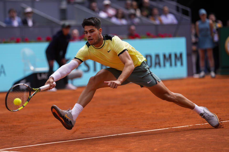 Carlos Alcaraz, of Spain, returns the ball to Alexander Shevchenko, of Kazakhstan, during the Mutua Madrid Open tennis tournament in Madrid, Friday, April 26, 2024. (AP Photo/Manu Fernandez)